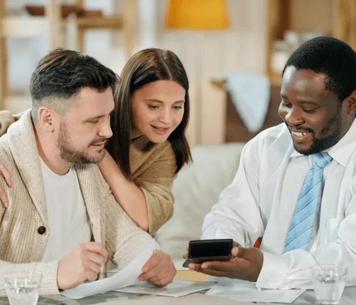 content-man-advising-young-couple-on-home-loan-2021-09-24-03-00-43-utc_1280x854_via_10015_io